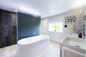 Photo of a modern bathroom with free standing bath, installed by Roots
